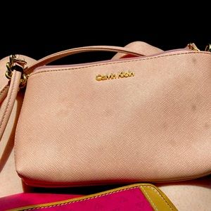 This is a light pink, small crossbody Calvin Klein